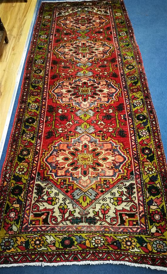 A Karajeh red ground rug 296 x 110cm